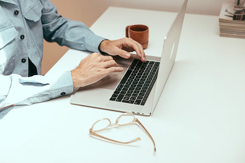 arbeiten mit Brille, Laptop und Kaffee